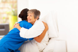 medical staff and patient hugging